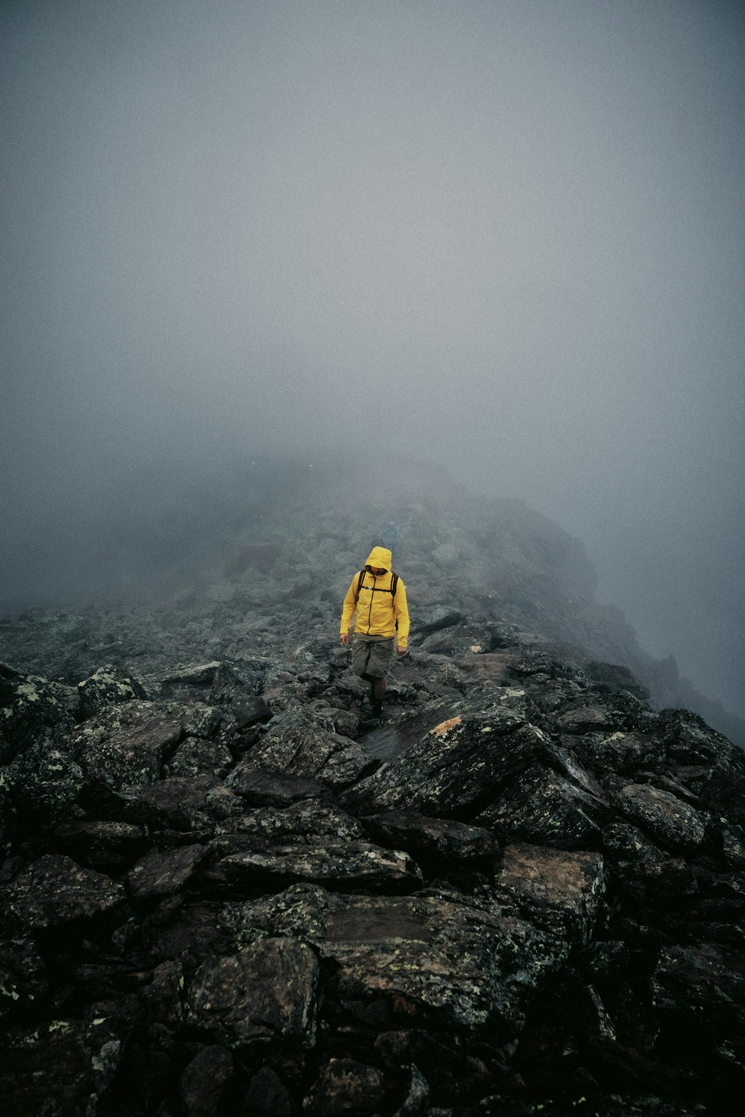 Hiker on foggy mountain ridge wearing insulated jacket — Best Insulated Jackets NZ 2026
