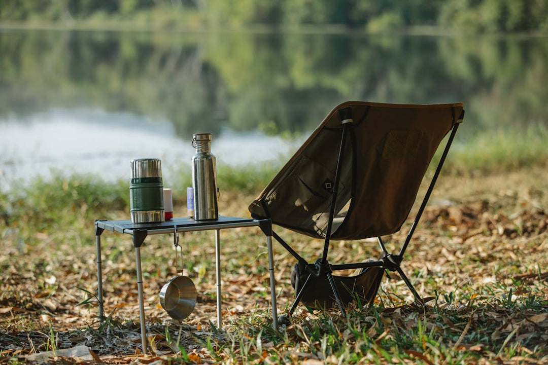 Camping chair by a lakeside with thermos — best camping chairs NZ