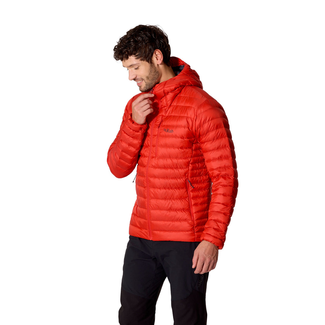 Man wearing the Rab Microlight Alpine Down Hoody in Dark Horizon and adjusting the hood.